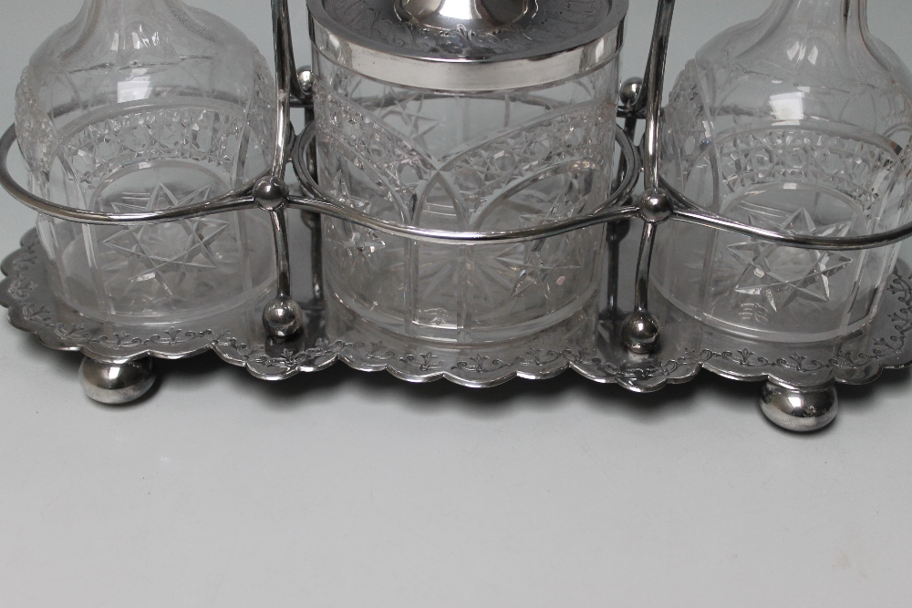 A LATE 19TH CENTURY `WALKER & HALL` SILVER PLATED TANTALUS, with two cut glass decanters and - Image 3 of 3