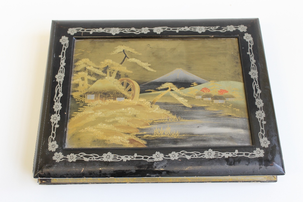 A JAPANESE LACQUERED ALBUM AND CONTENTS, containing postcards of Japan, Nagasaki, Tokyo, Geisha