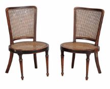 A pair of stained beech and caned occasional chairs, late 19th early 20th century, with rectangular