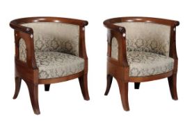 A pair of Art Nouveau walnut and upholstered tub armchairs, early 20th century, with decorative