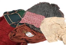 A collection of assorted fabrics and materials including throws, pillows, and bedding Please see