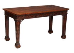 A George III style mahogany serving table, 19th century and later, with geometrically carved frieze