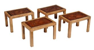 A harlequin set of four oak and parquetry inlaid low tables, early 20th century, the tops with
