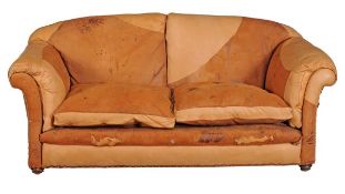 A leather upholstered two seater sofa, 20th century, with scroll arms and on turned front feet