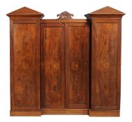 A William IV mahogany compactum linen press, circa 1835, the central section with scroll motif