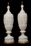 A pair of ceramic lamp bases, 20th century, in the form of lidded vases with classical figure