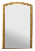 A giltwood and composition wall mirror, second half 19th century, the arched rectangular plate