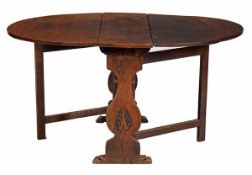 An oak gateleg table, early 18th century and later, the oval top above baluster shaped sides carved