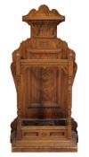 An Aesthetic period carved ash stick stand, circa 1880, with carved motif and scrolls above a