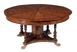 A mahogany and metal mounted concentric extending dining table, in the manner of Jupe, 20th