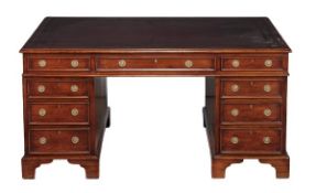 A mahogany twin pedestal partners desk, early 19th century, with tooled leather inset top and three