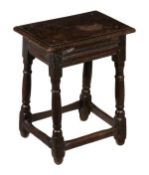 A Charles II oak joint stool, circa 1660 and later, the rectangular top above frieze with cut