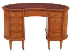 A Victorian inlaid satinwood and ebony strung kidney shaped desk, circa 1870, the leather inset top