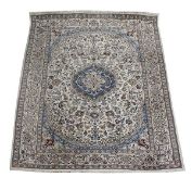 A Nain carpet, profusely decorated with floral and foliate motifs in polychrome on an ivory field,
