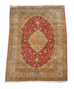 A Sarouk carpet, part silk, approximately 317cm x 195