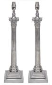 A pair of silver plated metal columnar table lamps, of recent manufacture, the electrical fitments