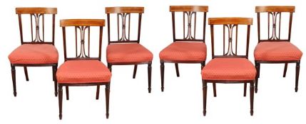 A set of six Regency mahogany dining chairs, circa 1815, with satin wood inlaid bars above fluted