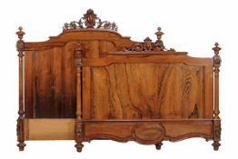 A Continental rosewood bed, last quarter of 19th century, with carved motif containing vacant