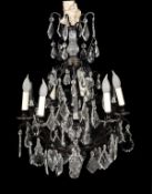 A metal and glass hung six light chandelier in Louis XV style, of recent manufacture, the