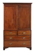 A George III mahogany linen press circa 1790 with a moulded cornice, the panelled doors enclosing