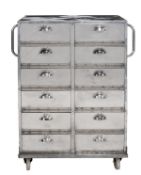 A polished metal medical cabinet, 20th century, with twelve short fall flap compartments and