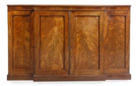 A mahogany breakfront cupboard, first half 19th century, with central double panelled cupboard