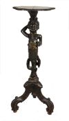A Continental, probably Italian carved and ebonised wood figural torchere stand, 19th century, the