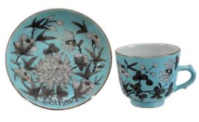 A Guangzhu coffe cup and saucer, each of typical form and decorated with chrysanthemum and other