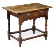A George III oak side table, circa 1760, the rectangular top above a frieze drawer, turned and