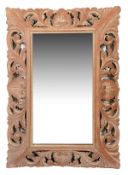 A Continental carved oak wall mirror, in 18th century style, late 19th century, the rectangular