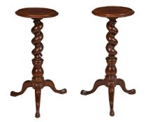 A pair of mahogany pedestal plant stands, first half 19th century, with circular tops above barley