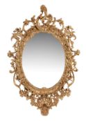 A carved giltwood and composition wall mirror, circa 1860 and later with shell motif to top above