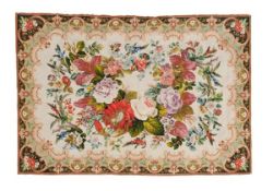 A needlework panel, 20th century, centred by flowers with a scrolling border, 90 x 130cm
