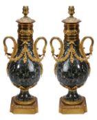 A pair of Continental gilt bronze mounted green serpentine marble urns fitted as table lamps, early