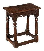 A Charles II oak joint stool, circa 1660 and later, the rectangular top above carved frieze on