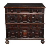 A Charles II oak chest of drawers, circa 1660, the rectangular top above four mitre panelled