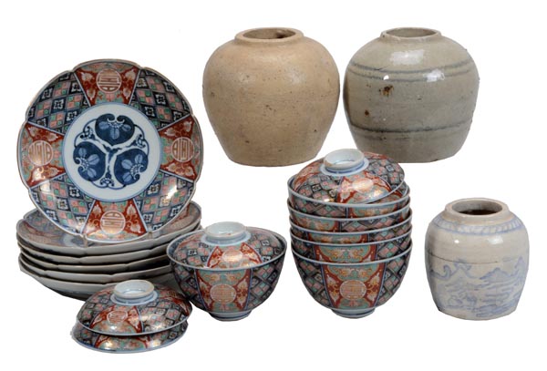 A set of six Japanese Imari saucers and five lidded bowls decorated with polychrome geometric and