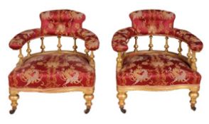 A pair of Victorian giltwood and upholstered tub armchairs, circa 1860, both with shaped backs