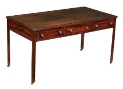 A Regency mahogany writing table, circa 1815, with leather inset top with reeded edge above three