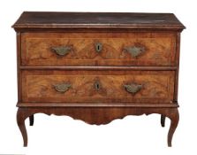 A Continental walnut commode, mid 18th century, with cross banded and inlayed top above two long