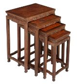 A Chinese hardwood set of quartetto tables, early 20th century, with Greek key style carving to