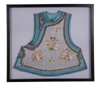 A Chinese purple ground silk waistcoat embroidered with blooming flowers and peaches, 57cm wide,