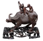 A Chinese wood carving of a water buffalo and boy group, on a carved wood stand, 20th century, 40cm