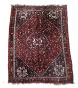 A Quashqai carpet, the crimson field decorated profusely with foliate motifs throughout, with