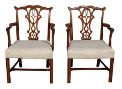 A pair of George III style mahogany elbow chairs, 19th century, with decorative splat backs in the