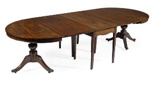 A George III mahogany extending dining table, circa 1780, incorporating two D-ends, a central