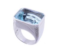 An aquamarine and diamond ring, the rectangular step cut aquamarine, estimated to weigh 26.00