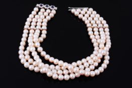 A four row cultured pearl necklace, the 8.6 mm cultured pearls, on a string, with polished spacers