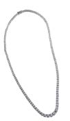 * A graduated diamond necklace, the brilliant cut diamonds in four claw settings to a concealled