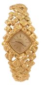 Omega, a lady`s 18 carat gold wristwatch, ref. 701570, the two piece case with gold dial, baton